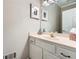 Small bathroom featuring white vanity, pink countertop, framed artwork, and simple decor at 2676 Varner Ne Dr, Atlanta, GA 30345