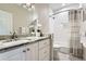 Bright bathroom featuring granite countertop, white cabinets, tiled shower and new fixtures at 2676 Varner Ne Dr, Atlanta, GA 30345