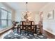 Elegant dining room with hardwood floors, chandelier lighting, and large windows creating an inviting space for entertaining guests at 2676 Varner Ne Dr, Atlanta, GA 30345