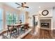Dining room with hardwood floors, fireplace, ceiling fan, and natural light from large windows at 2676 Varner Ne Dr, Atlanta, GA 30345