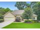 Charming ranch-style home featuring a two-car garage, manicured lawn, and mature trees, perfect for suburban living at 2676 Varner Ne Dr, Atlanta, GA 30345