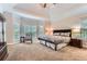 Large main bedroom with tray ceiling, carpeted floor, and multiple windows at 2676 Varner Ne Dr, Atlanta, GA 30345