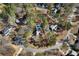 Aerial view of a home with a backyard pool surrounded by lush trees in a residential neighborhood at 4970 Lost Mountain Nw Trce, Kennesaw, GA 30152