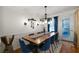 Cozy dining room featuring modern lighting, hardwood floors, and backyard access at 4970 Lost Mountain Nw Trce, Kennesaw, GA 30152