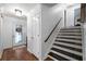 Inviting home entryway with wood flooring, a decorative front door, and staircase leading to the second level at 4970 Lost Mountain Nw Trce, Kennesaw, GA 30152