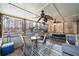 Relaxing screened-in porch with ceiling fans, comfortable seating, and views of the backyard swimming pool at 4970 Lost Mountain Nw Trce, Kennesaw, GA 30152