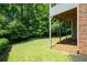 Expansive backyard with lush green grass and mature trees offers a serene outdoor space at 5418 Amity Dr, Powder Springs, GA 30127