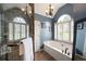 Bathroom with a soaking tub and a glass enclosed shower, with neutral paint colors at 5418 Amity Dr, Powder Springs, GA 30127