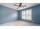 Cozy bedroom with blue walls, carpet, and a window with plantation shutters at 5418 Amity Dr, Powder Springs, GA 30127