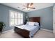 Comfortable bedroom with blue walls, carpet, ceiling fan, and a window with plantation shutters at 5418 Amity Dr, Powder Springs, GA 30127