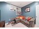 Bonus room featuring a gray sectional sofa, built-in shelving, and stylish decorations at 5418 Amity Dr, Powder Springs, GA 30127