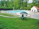 Community pool with lounge chairs and umbrellas provides a relaxing retreat at 5418 Amity Dr, Powder Springs, GA 30127