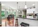 Bright eat-in kitchen features granite counters, stainless steel appliances, and adjacent dining nook with wooded views at 5418 Amity Dr, Powder Springs, GA 30127