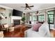 Comfortable living room with hardwood floors, a brick fireplace, and ample natural light at 5418 Amity Dr, Powder Springs, GA 30127