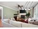Bright living room featuring hardwood floors, a brick fireplace, and comfortable seating at 5418 Amity Dr, Powder Springs, GA 30127