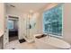 Bright bathroom with a standalone tub, glass-enclosed shower, and large window at 816 S Columbia Dr, Decatur, GA 30030
