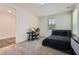 Modern bedroom with gray carpet, a black bed, and a desk for a home office setup at 816 S Columbia Dr, Decatur, GA 30030