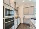 Charming kitchen featuring stainless steel appliances, light gray cabinets, and hardwood floors at 816 S Columbia Dr, Decatur, GA 30030