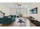 An open living room with a ceiling fan, hardwood floors, and contemporary furnishings that fill the space at 816 S Columbia Dr, Decatur, GA 30030