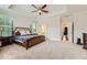 Spacious main bedroom with a tray ceiling, carpet floors and a four-poster bed at 816 S Columbia Dr, Decatur, GA 30030