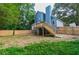 View of the backyard showing the raised deck with a stairway to the yard and a wooden fence at 909 Shiloh Ridge Nw Run, Kennesaw, GA 30144