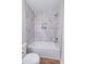 Bathroom featuring a bathtub and a shower with gray-and-white marble tiling with a niche at 909 Shiloh Ridge Nw Run, Kennesaw, GA 30144