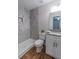 Bathroom featuring a marble tiled shower, modern toilet, and granite vanity at 909 Shiloh Ridge Nw Run, Kennesaw, GA 30144