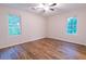 Bright bedroom featuring hardwood floors, a ceiling fan, and natural light from the windows at 909 Shiloh Ridge Nw Run, Kennesaw, GA 30144