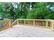 Wooden deck featuring wood railings overlooking the wooded backyard at 909 Shiloh Ridge Nw Run, Kennesaw, GA 30144