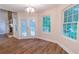 Bright dining area featuring hardwood floors, french doors leading to an outdoor deck, and views of the backyard at 909 Shiloh Ridge Nw Run, Kennesaw, GA 30144