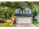 Charming two-story home with blue siding, black shutters, and a well-maintained front yard and a two car garage at 909 Shiloh Ridge Nw Run, Kennesaw, GA 30144