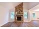 Spacious living room with a stone fireplace, hardwood floors, and bright windows at 909 Shiloh Ridge Nw Run, Kennesaw, GA 30144