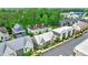 A high angle showcases modern neighborhood homes with metal roofs, and organized street parking at 10862 Serenbe Ln, Chattahoochee Hills, GA 30268