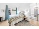 Bright bedroom with floral bedding, hardwood floors, and modern light fixture, creating a cozy and stylish space at 10862 Serenbe Ln, Chattahoochee Hills, GA 30268