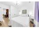 Comfortable bedroom with hardwood floors, ample natural light, and a doorway to an office, creating a relaxing retreat at 10862 Serenbe Ln, Chattahoochee Hills, GA 30268