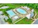 Aerial shot of a pristine community pool, complete with lounge chairs, umbrellas, and manicured landscaping at 10862 Serenbe Ln, Chattahoochee Hills, GA 30268