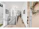 Bright entryway featuring hardwood floors, white walls, a modern railing and lots of natural light from the nearby windows at 10862 Serenbe Ln, Chattahoochee Hills, GA 30268