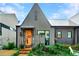 Lovely single-Gathering home with unique architecture, featuring an inviting orange front door at 10862 Serenbe Ln, Chattahoochee Hills, GA 30268