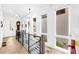 Well-lit hallway with hardwood floors, white walls, and modern lighting, providing a seamless transition between living spaces at 10862 Serenbe Ln, Chattahoochee Hills, GA 30268