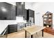 Modern kitchen featuring dark cabinets, stainless steel appliances, a butcher block island, and hardwood floors at 10862 Serenbe Ln, Chattahoochee Hills, GA 30268