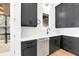 Modern kitchen with dark cabinets, white countertops, stainless steel appliances, and a view of the outside patio at 10862 Serenbe Ln, Chattahoochee Hills, GA 30268