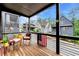 Cozy covered porch with wood flooring, showcasing a pleasant neighborhood view at 10862 Serenbe Ln, Chattahoochee Hills, GA 30268