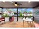 Relaxing covered porch features wood flooring and views of the surrounding neighborhood homes at 10862 Serenbe Ln, Chattahoochee Hills, GA 30268