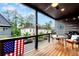 Charming covered porch with seating, views of the surrounding neighborhood, and a ceiling fan at 10862 Serenbe Ln, Chattahoochee Hills, GA 30268