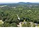 Aerial view of property surrounded by trees and mountain view at 1534 River Rock Trce, Woodstock, GA 30188