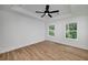 Bright bedroom features hardwood floors, neutral walls, and a ceiling fan at 1534 River Rock Trce, Woodstock, GA 30188