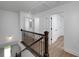 Hallway and staircase featuring wood railing and a view of the exterior at 1534 River Rock Trce, Woodstock, GA 30188