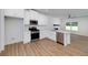 Contemporary kitchen showcasing white cabinets, stainless steel appliances, and an open floor plan at 1534 River Rock Trce, Woodstock, GA 30188