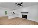 Open-concept living room with fireplace and a view of the kitchen with white cabinets at 1534 River Rock Trce, Woodstock, GA 30188