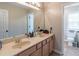 Well-lit bathroom with double sink vanity and adjacent toilet at 3906 Elm Trace Ct, Loganville, GA 30052